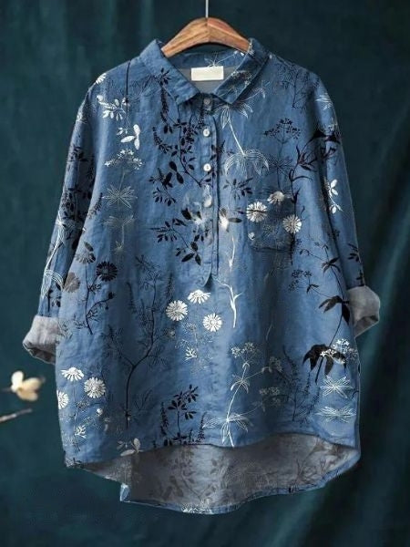 Woman in a stylish floral button-up blouse paired with jeans, showcasing casual spring fashion.