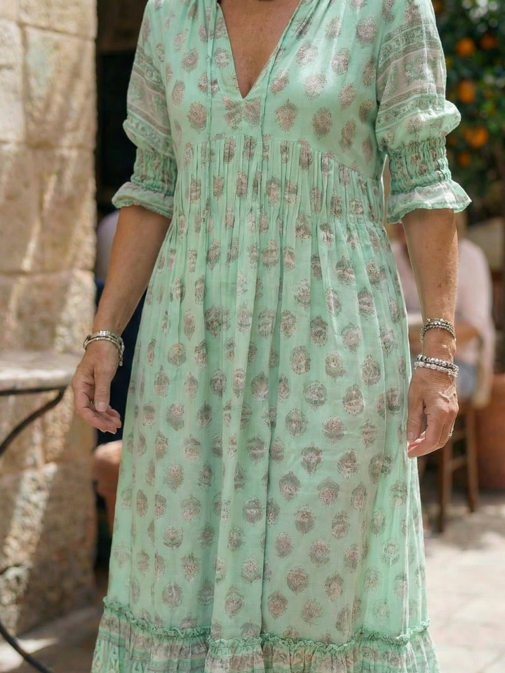 Lightweight floral V-neck midi dress, ideal for women's casual spring and summer fashion. Features a relaxed fit.