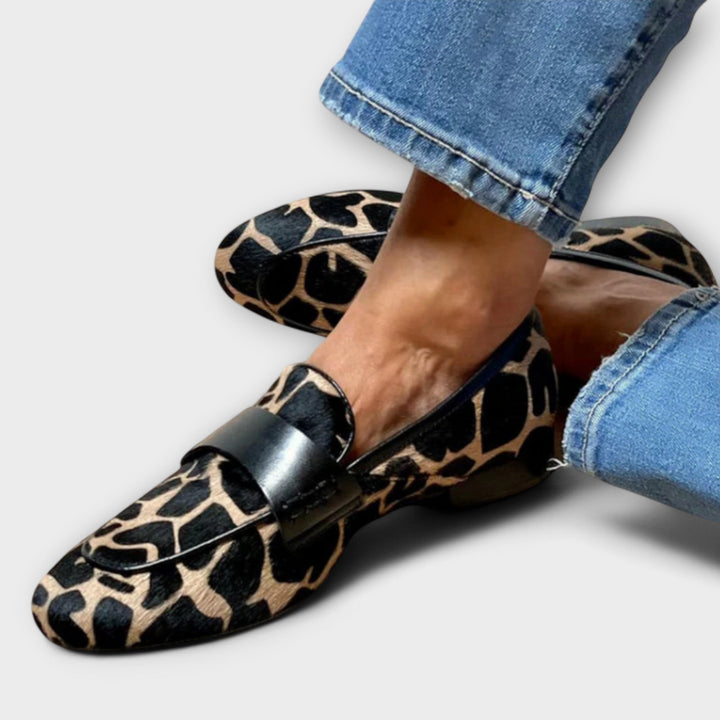 Women's sharp style animal print loafers. Elegant slip-on shoes for a chic and bold fashion statement.