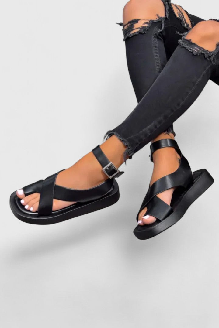 Stylish women's flat sandals with secure, adjustable straps for summer comfort.
