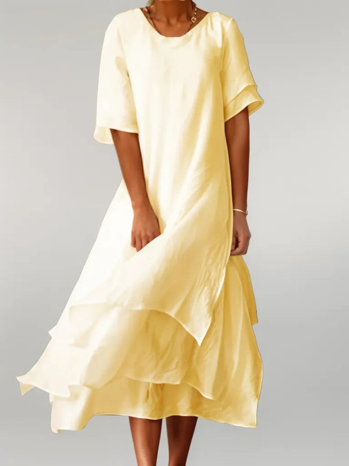 Chic women's midi dress with elegant layered design, showcasing soft, flowy fabric for summer style.