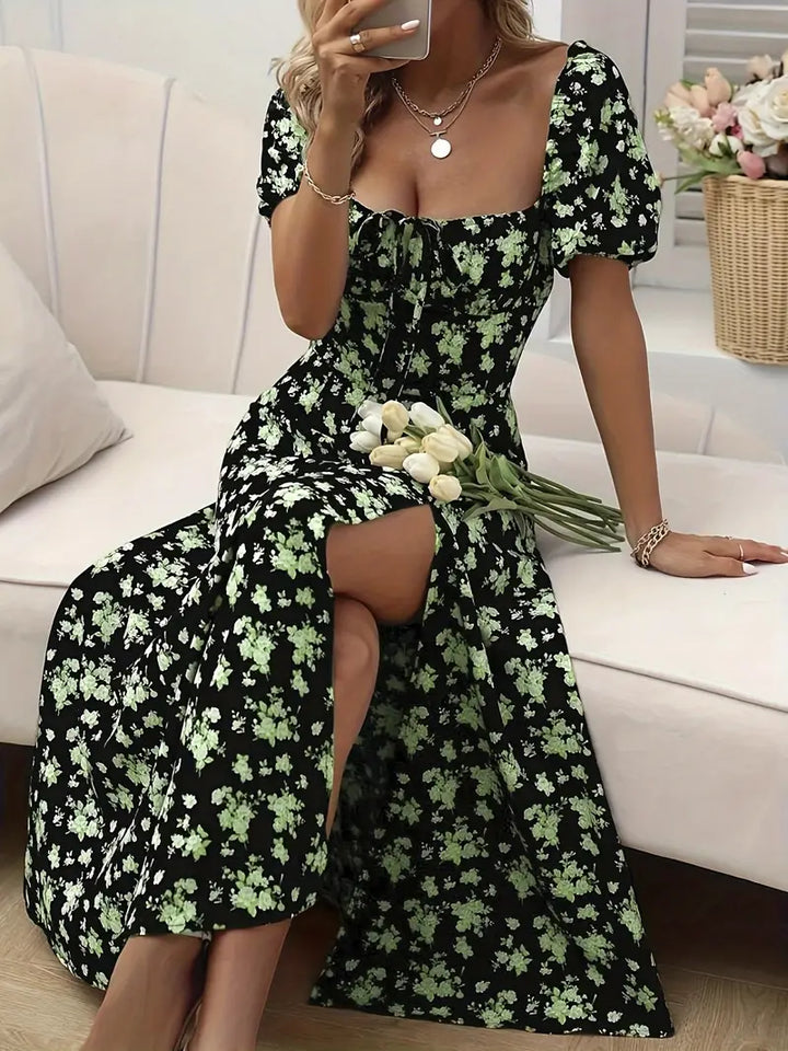 Women's floral A-line midi dress with distinctive puff sleeves & a subtle split hem, chic style.