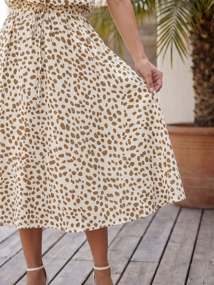 Overall vibrant print pattern on a women's button-front midi dress, a stylish choice for summer casual fashion.