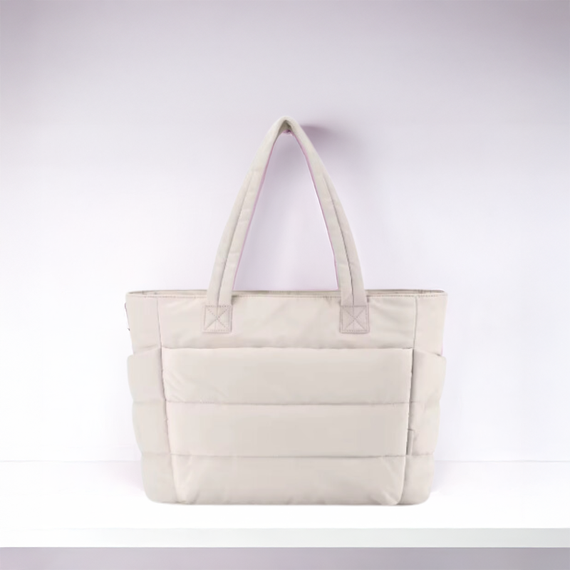 Fashionable women's puffy shoulder bag with quilted design, soft texture, ideal for travel.