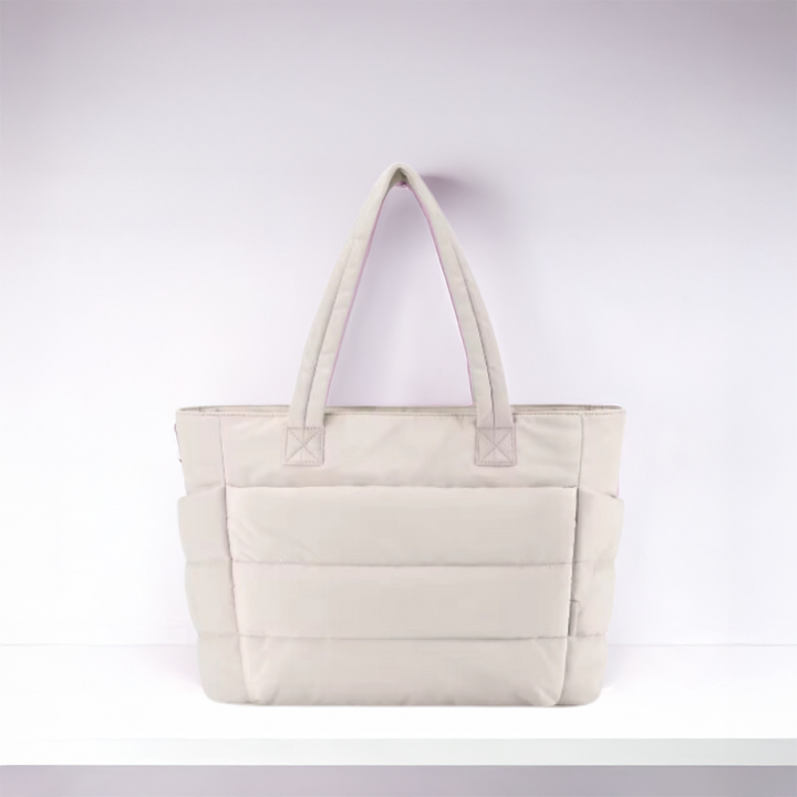 Fashionable women's puffy shoulder bag with quilted design, soft texture, ideal for travel.
