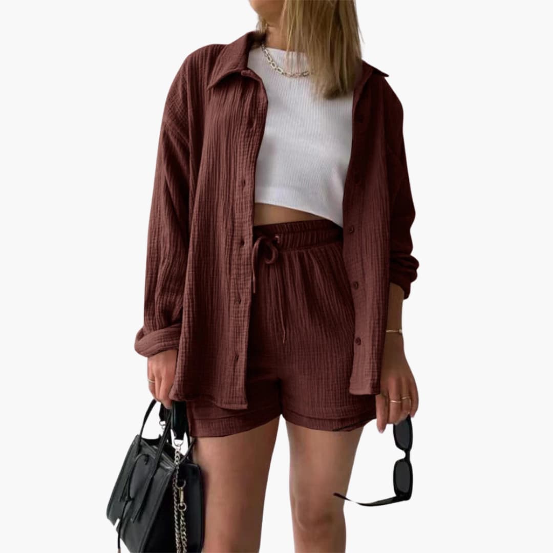 Side profile of woman wearing a coordinated three-piece summer set with a shirt, crop top & high-waist shorts.