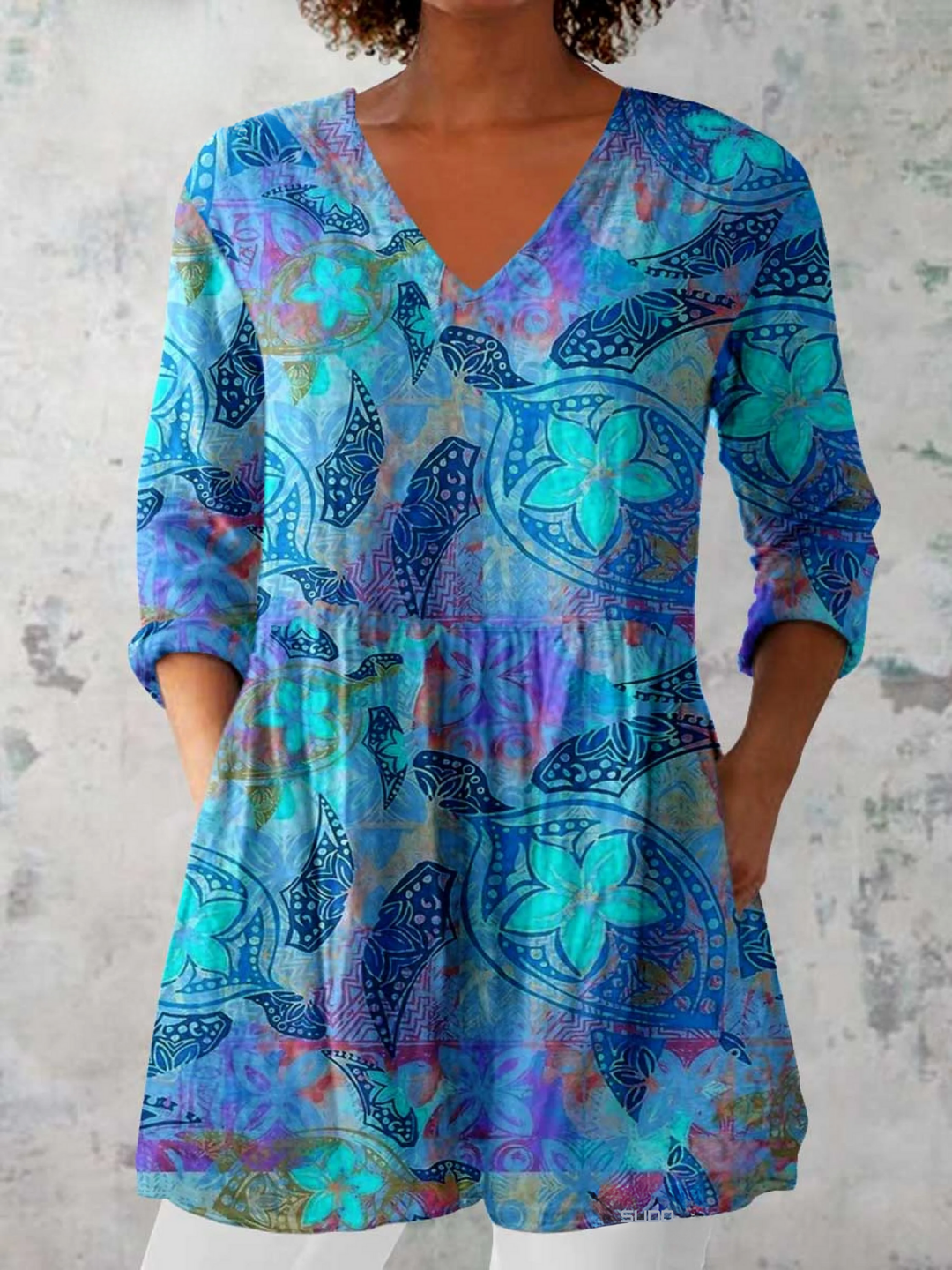 Elegant blue women's flowy V-neck blouse, perfect for casual chic or stylish everyday wear. Loose fit top.