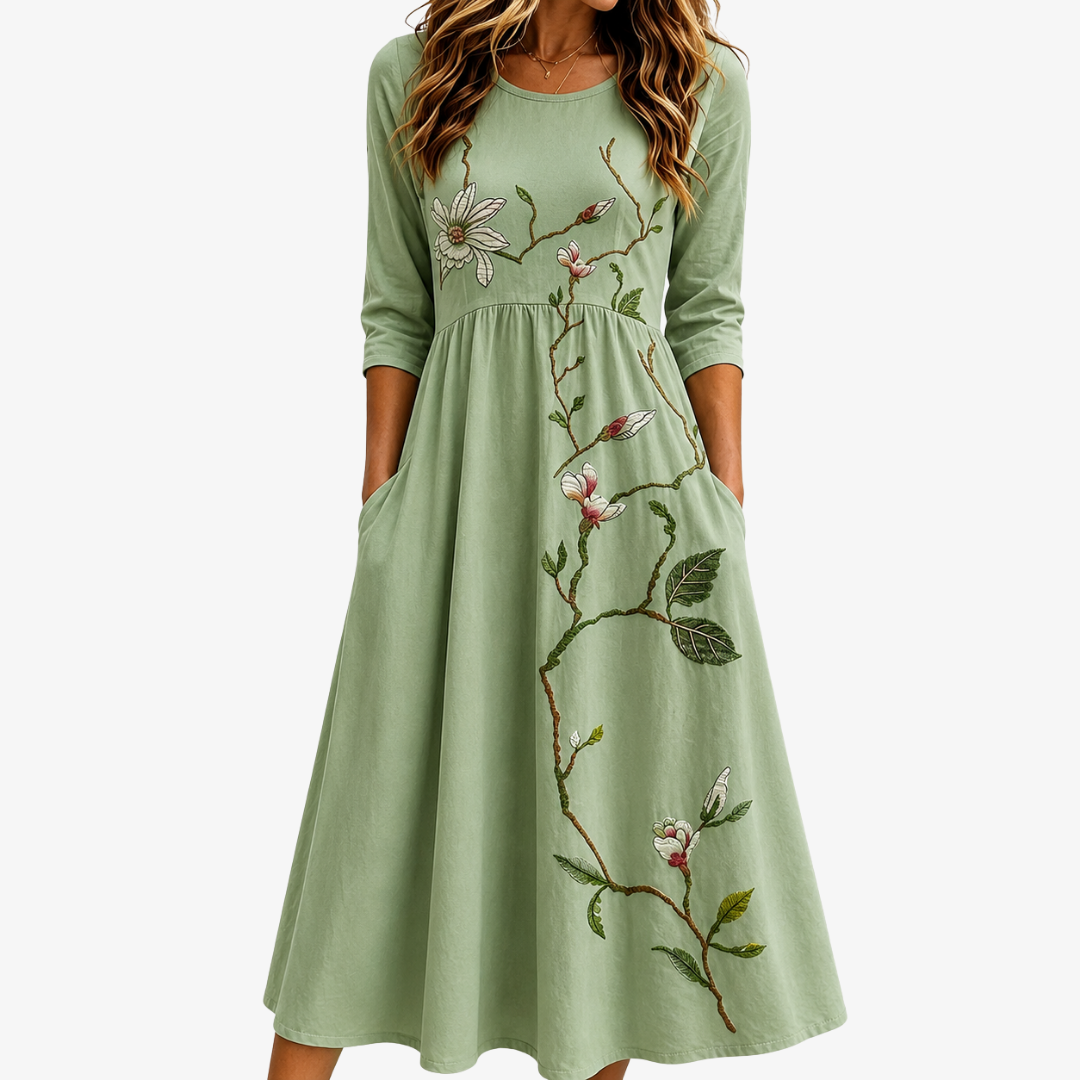 Women's elegant sage green midi dress with floral print. Flowy and comfortable, perfect for summer casual wear.