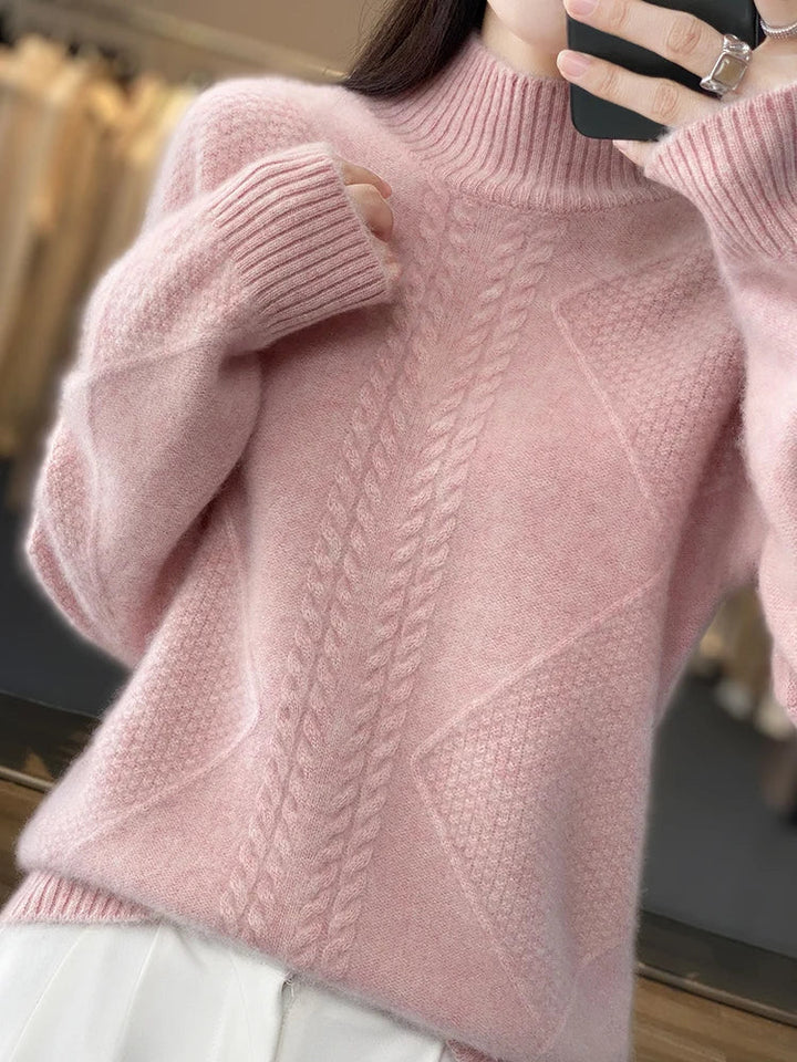 Grey women's cashmere roll neck sweater with a beautiful cable knit, offering soft warmth.