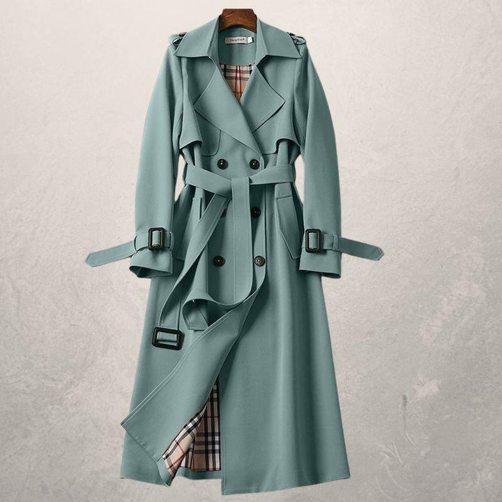Stylish women's double-breasted trench coat. Durable fabric, long silhouette for timeless fashion.
