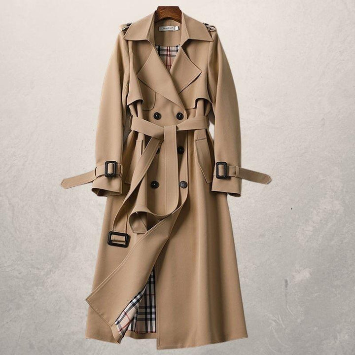 Chic women's double-breasted belted trench coat. Modern long outerwear for versatile layering.
