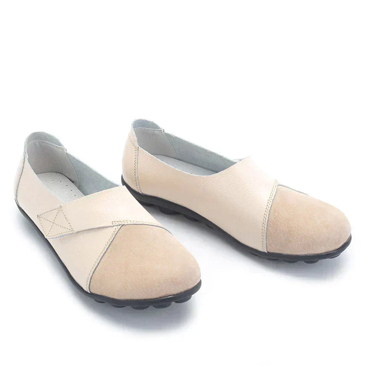 Easy-wear unisex slip-on flats, round toe design, stitched panels for a stylish casual look.