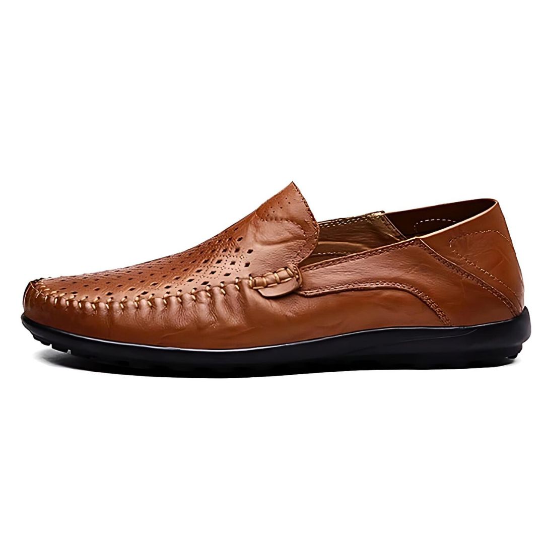 Classic men's perforated slip-on loafers with a flat sole, suitable for versatile casual and smart-casual looks.
