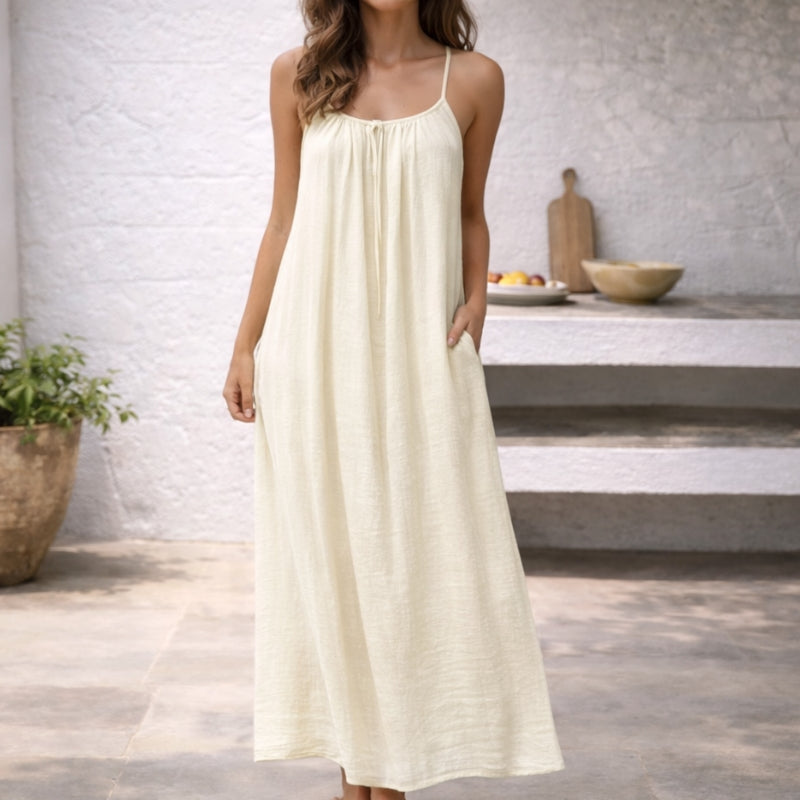 Close-up of the delicate spaghetti straps on a women's elegant summer maxi sundress.