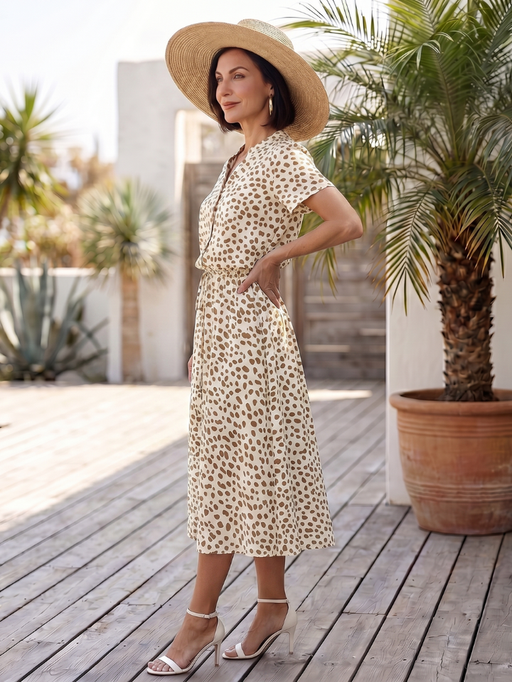 Flowing hemline of a women's printed belted midi dress, showcasing its relaxed fit and elegant movement.