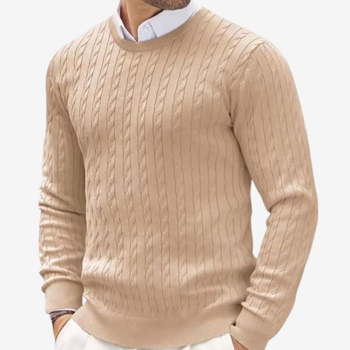 Close-up of the intricate cable knit pattern on a men's crew neck winter sweater. High quality knitwear.