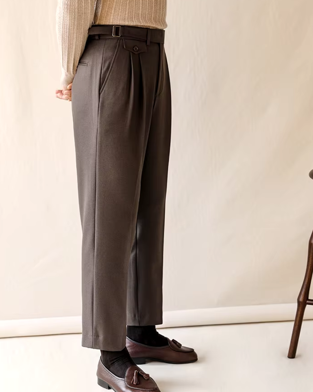 Full-length view of dark gray men's pleated dress pants, straight fit. Adjustable waist for a perfect fit.