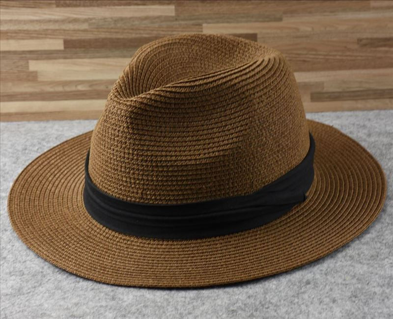 Fashionable women's straw sun hat with wide brim. Essential adjustable beach accessory for stylish summer protection.