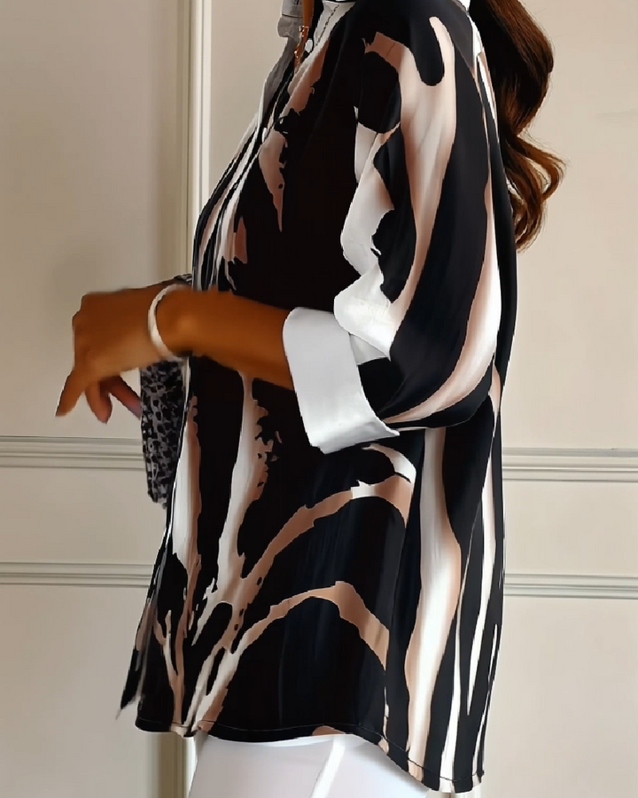 Casual women's printed top featuring an irregular design, stand collar, and comfortable long raglan sleeves.