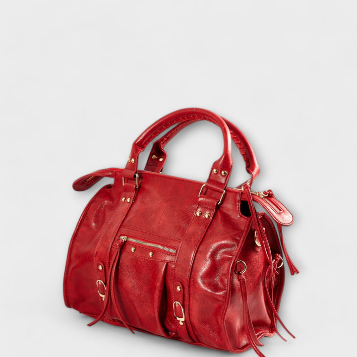 Chic cherry red women's laptop tote, made from vegan leather, functions as a stylish shoulder or crossbody bag.