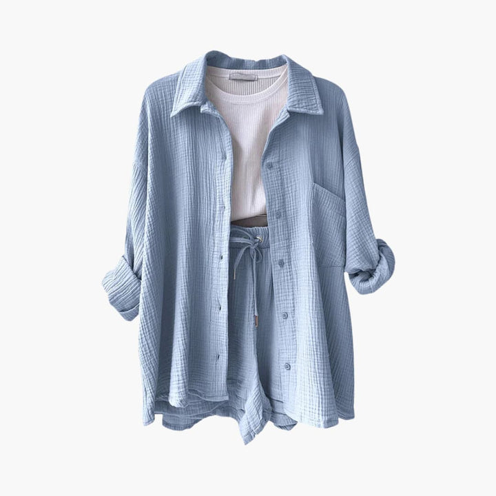 Stylish women's button-down shirt, matching crop top & high-waisted shorts three-piece set. Vacation style.