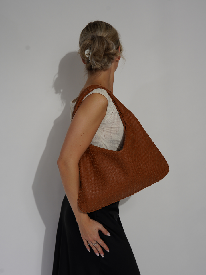 Modern women's one shoulder bag. Stylish vegan leather crossbody accessory.