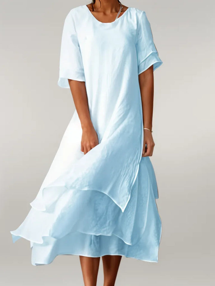 Women's elegant midi dress featuring a graceful layered design for a comfortable and chic versatile style.