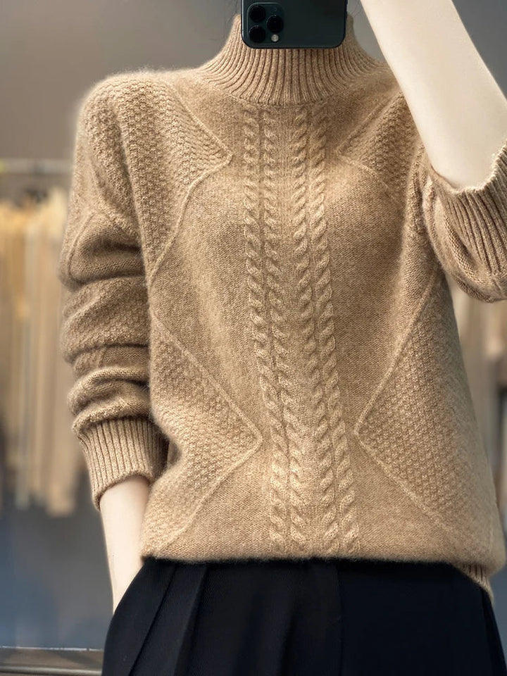 Cozy women's cashmere roll neck jumper in a warm cable knit, perfect for cold weather comfort.