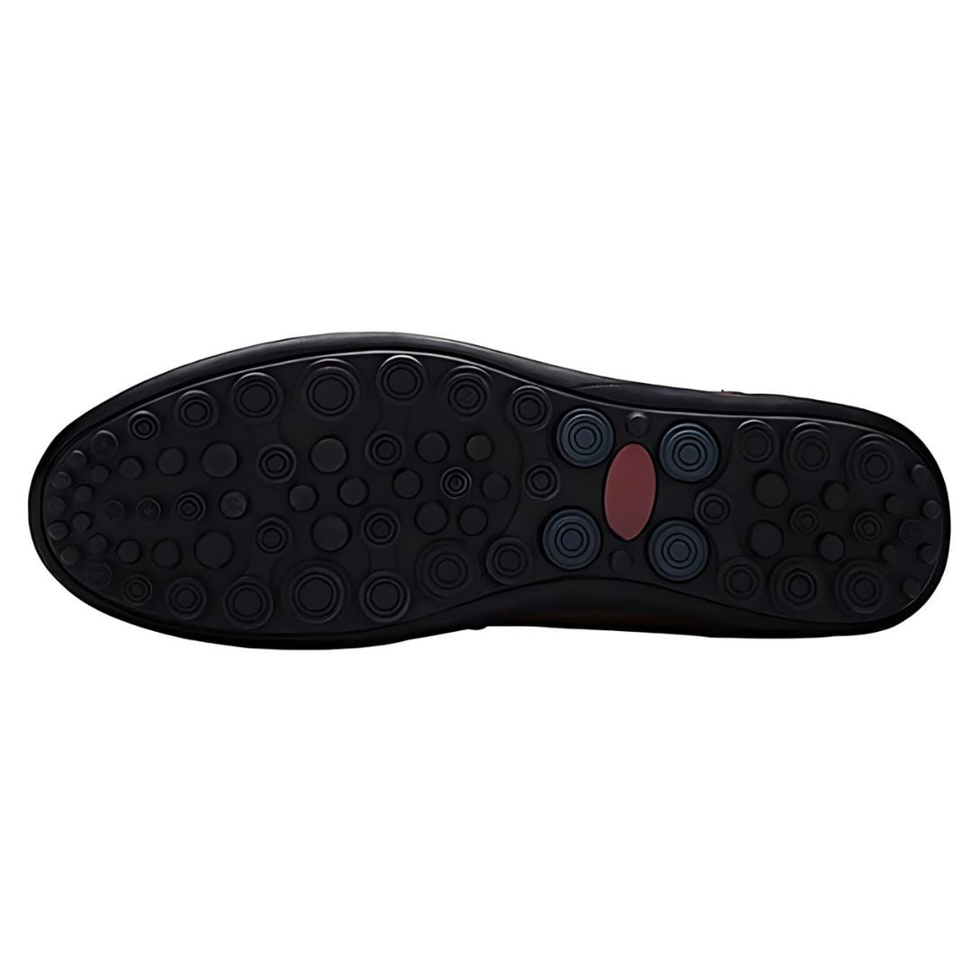 Close-up of men's perforated slip-on loafers, showcasing stitched panel and comfortable flat sole design.