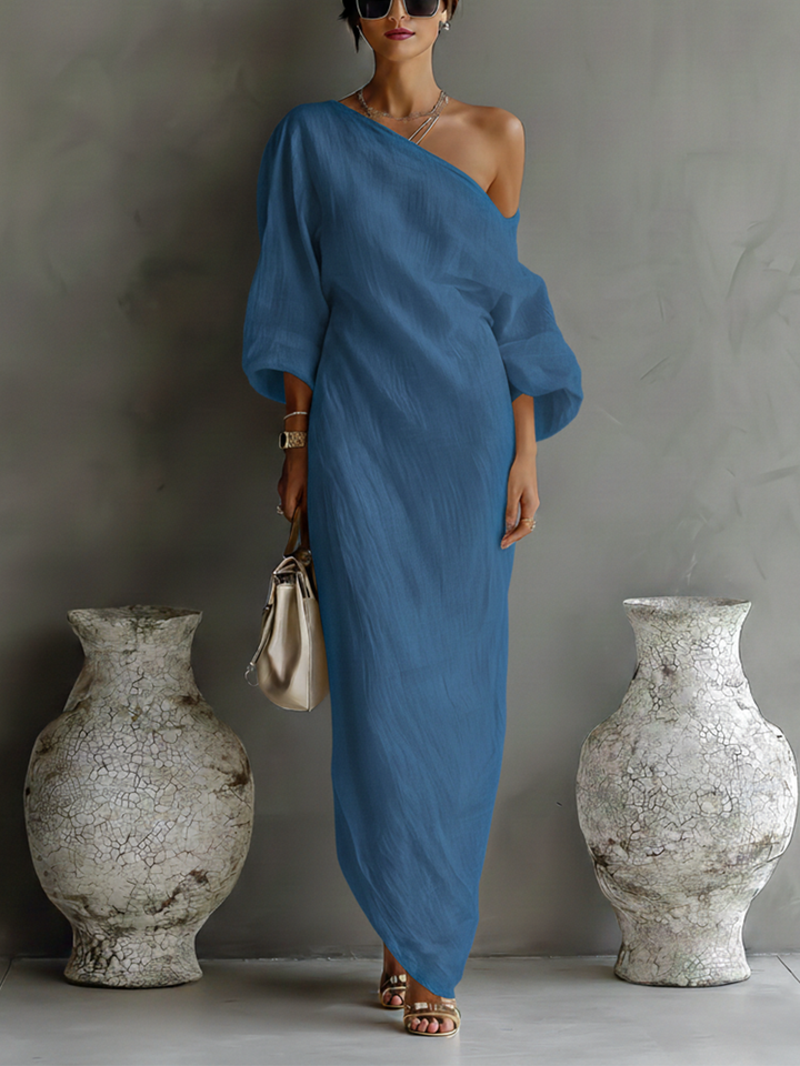 Sophisticated ivory one-shoulder evening gown for women. A flowing long maxi dress, perfect for formal occasions.