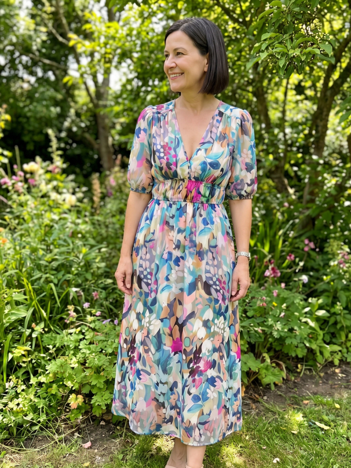 Modern abstract print women's midi dress with stylish puff sleeves. Comfortable V-neck for elegant casual summer looks.