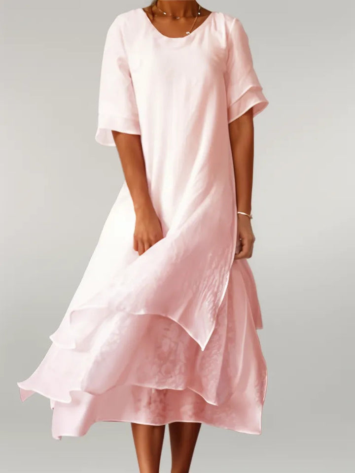 Elegant women's layered midi dress in a flowy fabric, perfect for versatile occasion wear.