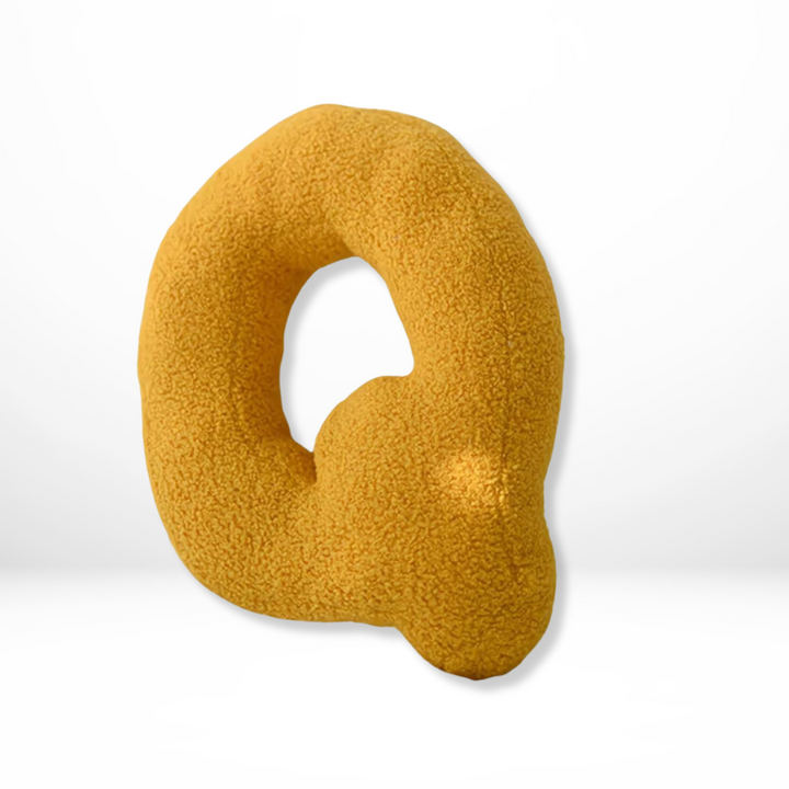 Vibrant velvet 'U' alphabet pillow, a soft decorative furnishing for modern and personalized homes.