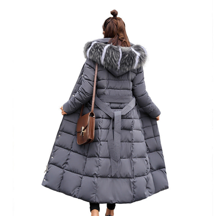 Versatile women's long quilted jacket, featuring a detachable hood and flattering belt for winter.