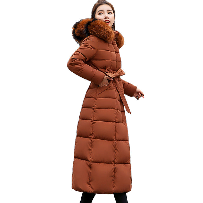 Elevate your winter fashion with this women's long quilted parka, featuring a hood and stylish belt.
