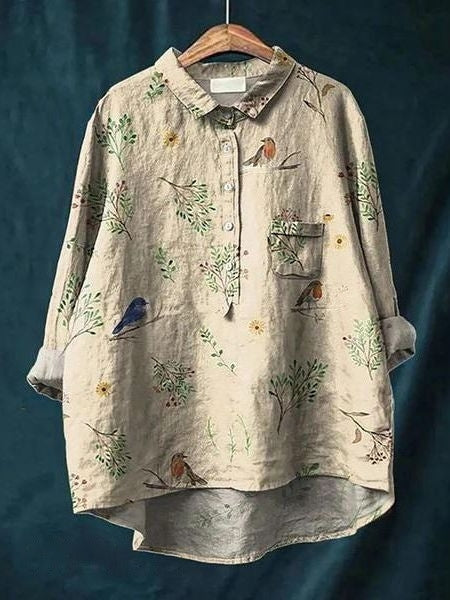 Close-up of collar & sleeves on a women's floral button-up blouse, relaxed fit, detailed print.