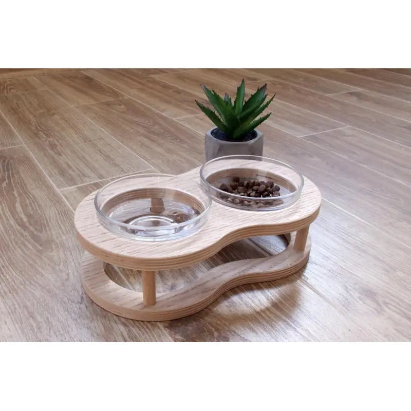 Non-slip elevated wooden pet bowl stand with two clear glass bowls for stable and comfortable dog & cat feeding.
