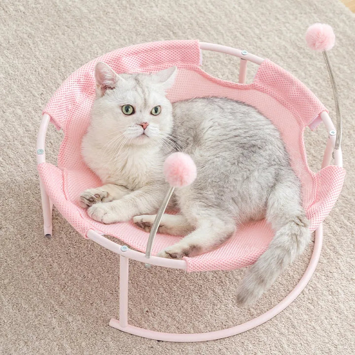 Cozy round cat bed/hammock with comfy fabric & built-in play balls; ideal pet lounger for relaxation.