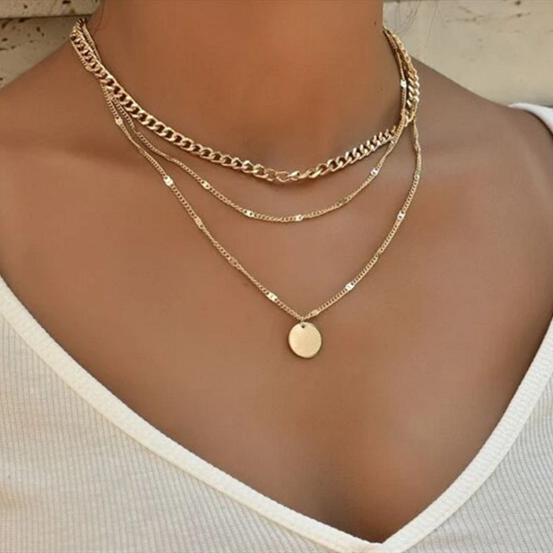 Elegant women's layered chain necklace set in gold, a versatile fashion accessory for everyday or statement wear.