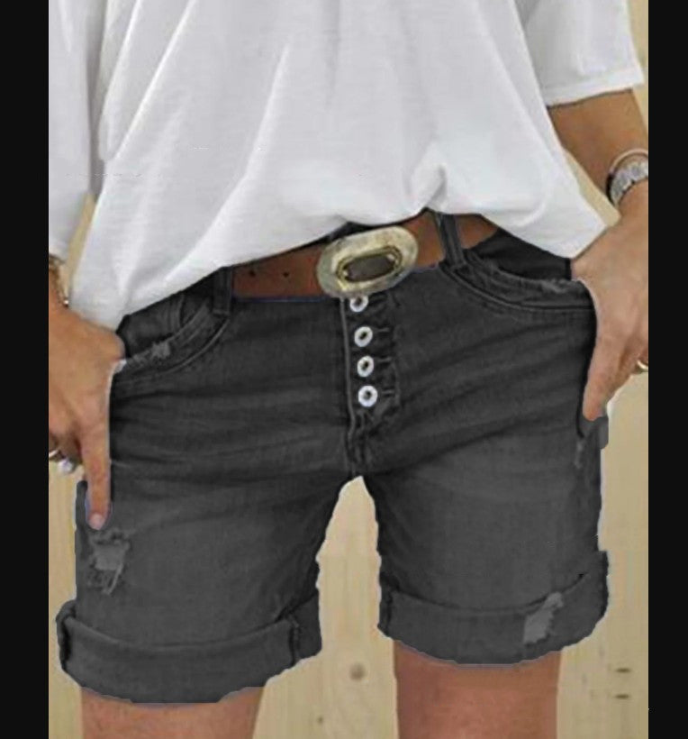 Trendy ladies' ripped denim shorts with a distressed finish, offering a fashionable casual style for summer.
