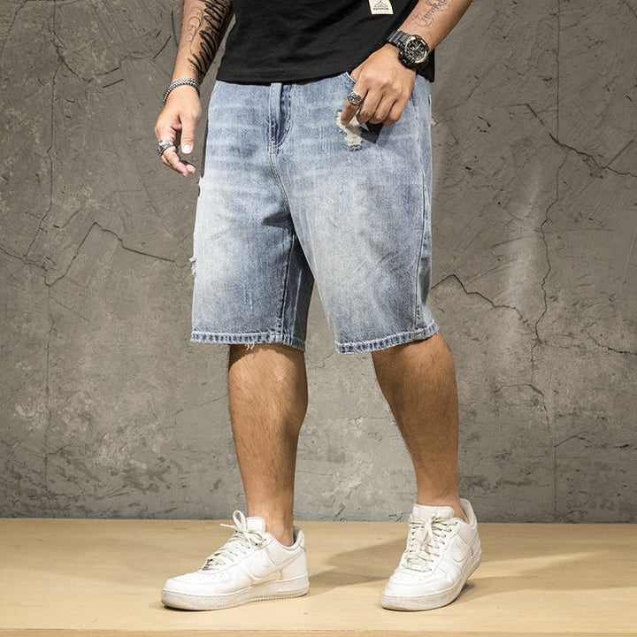 Men's light wash distressed ripped shorts, perfect for a casual summer style.