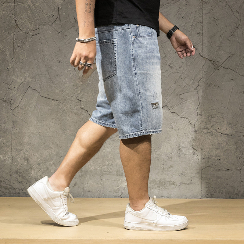 Stylish men's light wash ripped denim shorts, offering a relaxed fit for casual wear.