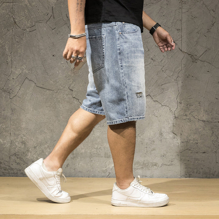 Stylish men's light wash ripped denim shorts, offering a relaxed fit for casual wear.