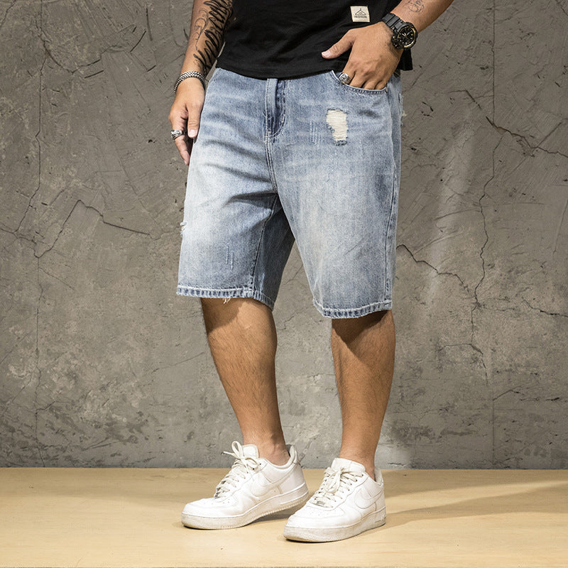 Men's casual light wash ripped shorts with a distressed finish, great for stylish summer outfits.