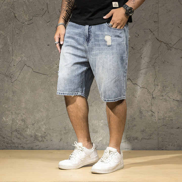 Men's casual light wash ripped shorts with a distressed finish, great for stylish summer outfits.
