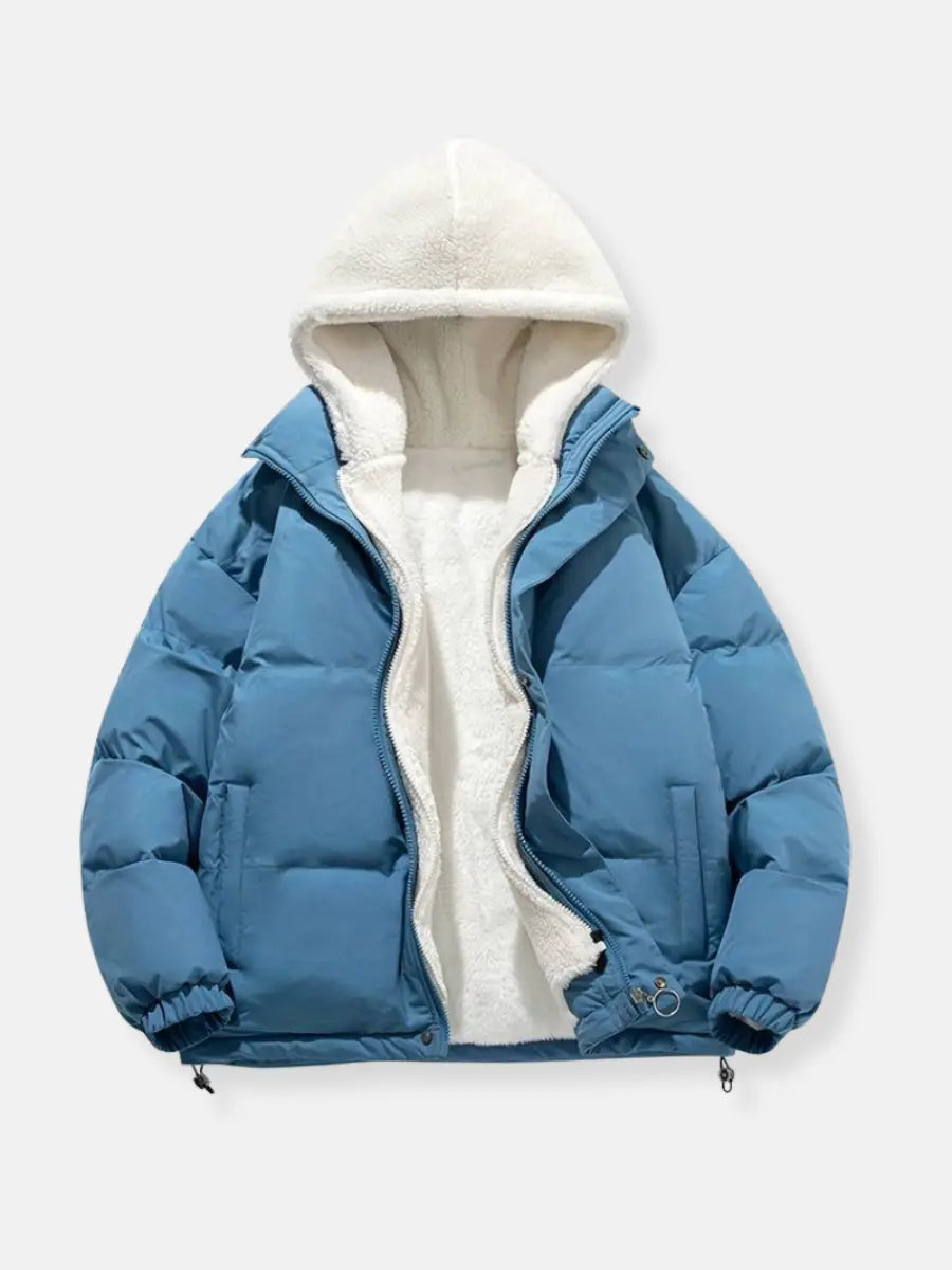 Long women's puffer jacket with a plush hood, providing full coverage and warmth for cold weather.