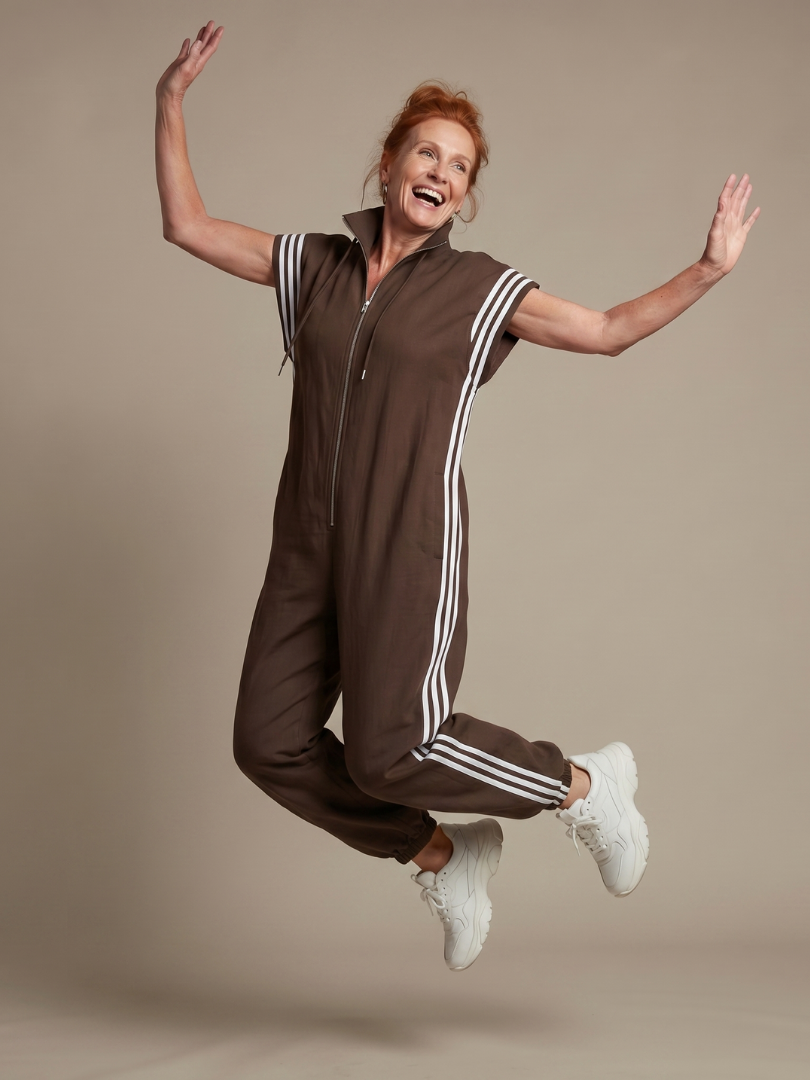 Stylish women's evening wear jumpsuit, zip front, full length, featuring elegant stripe panels.