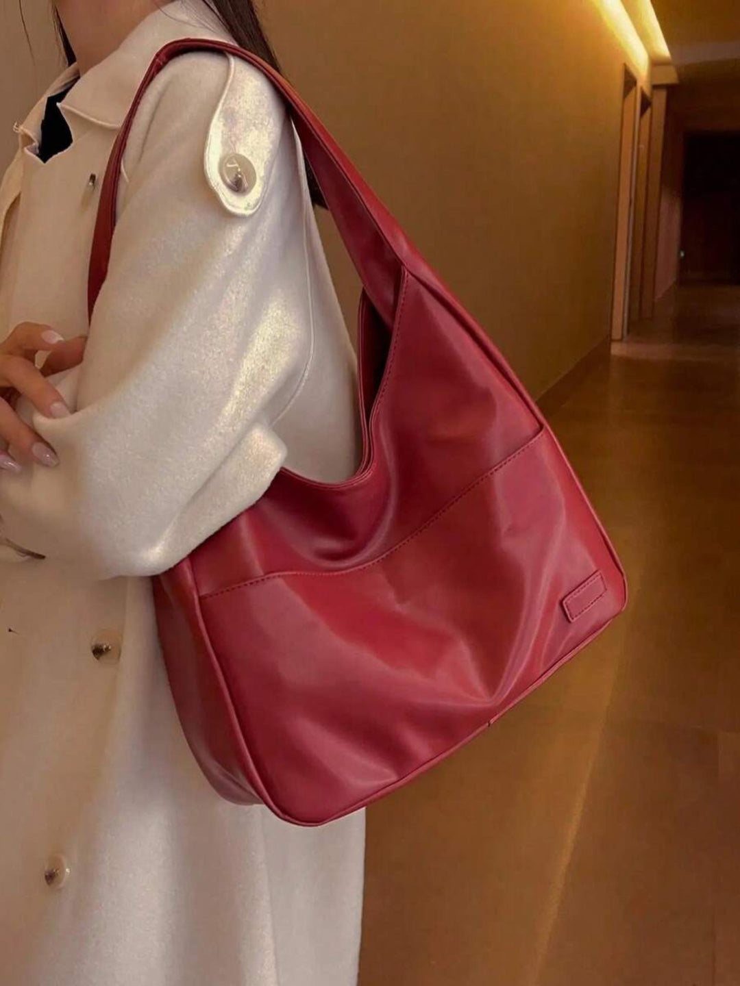 Side profile of a women's vegan leather shoulder bag. Slim, chic, and practical for everyday, work, or school.