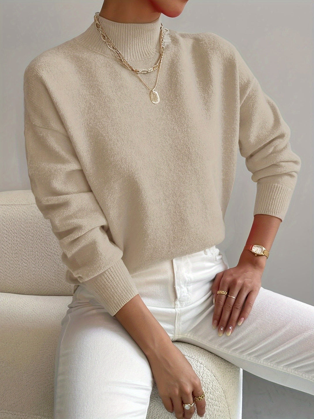 Cozy women's high neck knitted pullover, perfect for cold winter days.