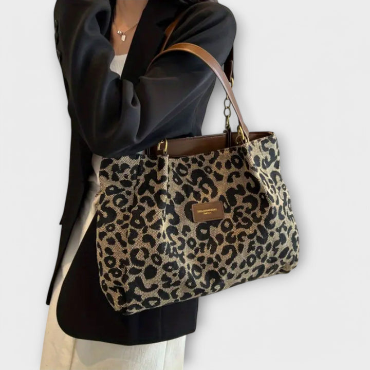 Chic women's leopard print canvas tote bag, versatile as a shoulder or crossbody bag for fashion-forward style.